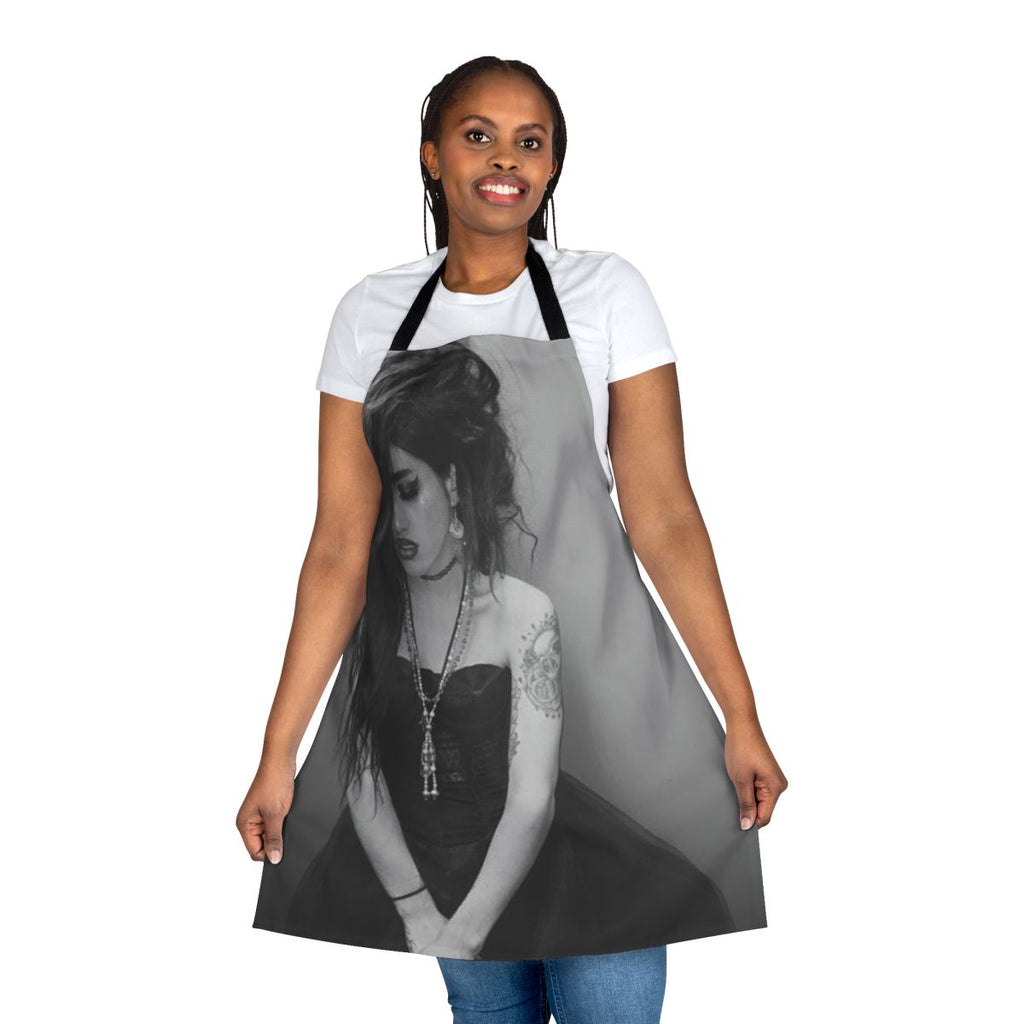 Black and white apron featuring the name "Adore Delano" and inspired by the drag performer