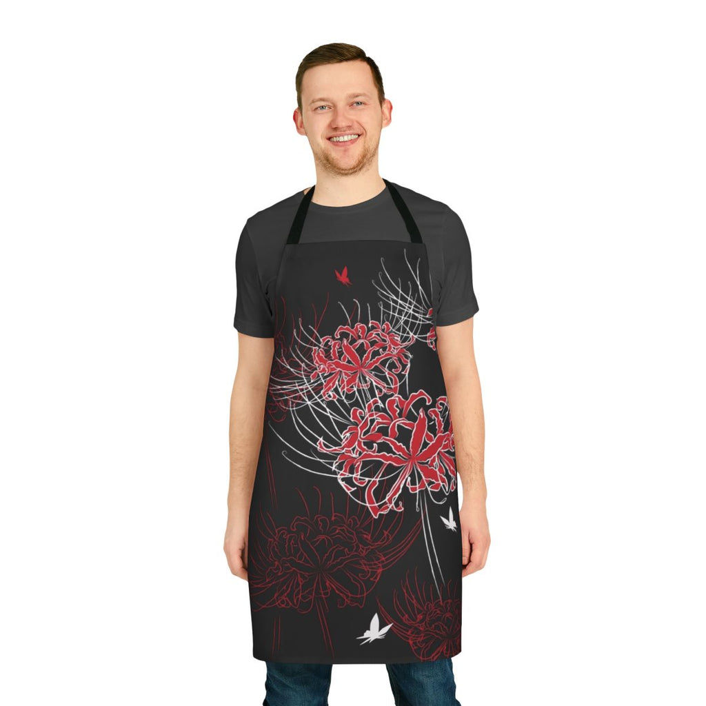 Close-up of a red and black butterfly perched on a spider lily flower, set against a Japanese-inspired floral pattern on an apron.