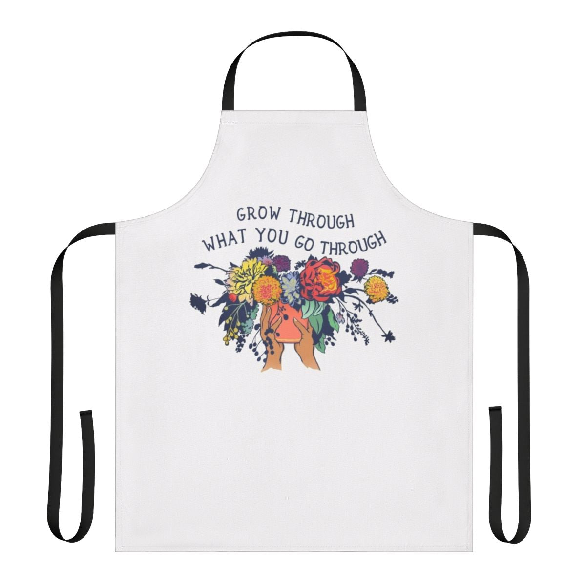 An apron with a floral bouquet design and the text "Grow Through What You Go Through"
