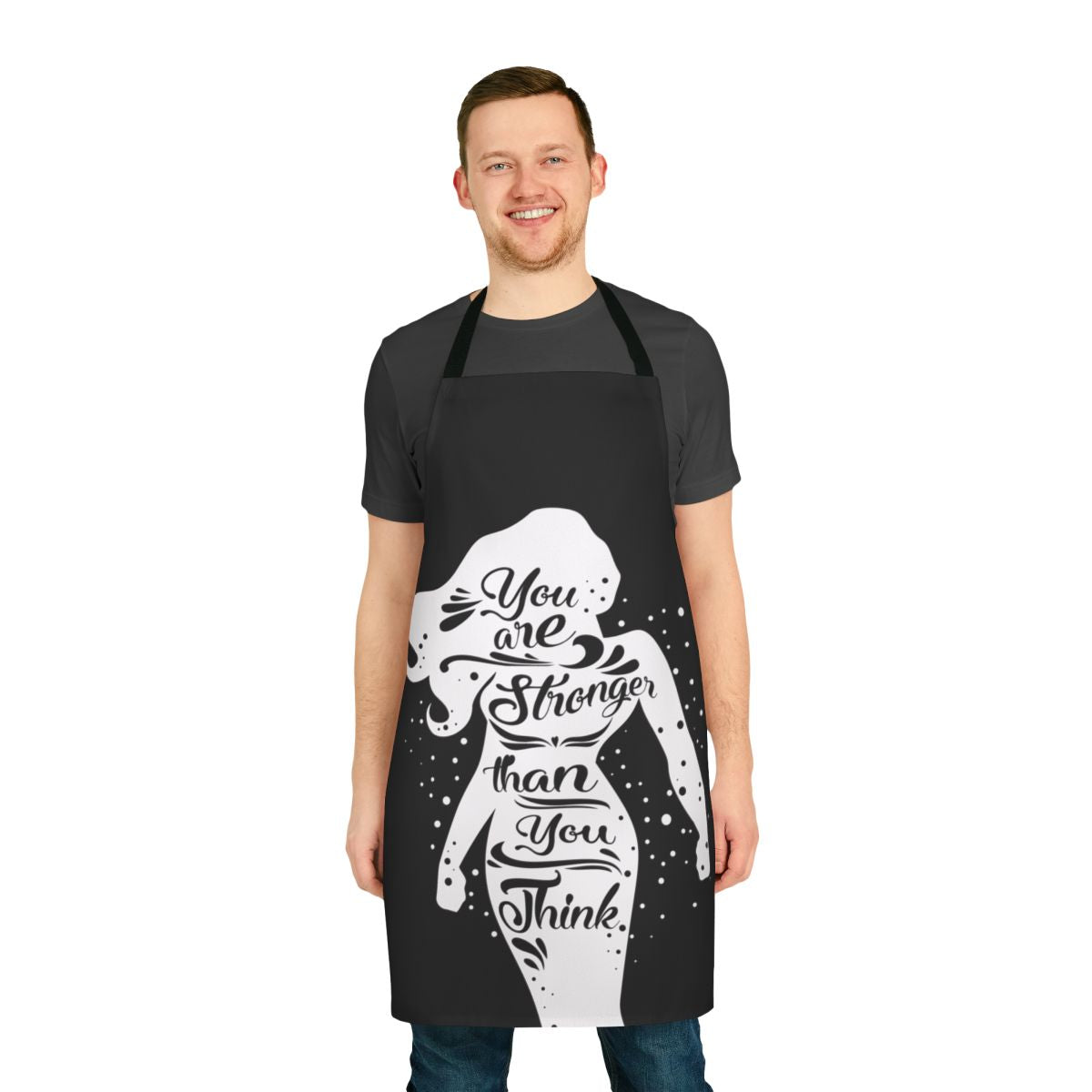 Woman wearing a black apron with the text "You Are Stronger" printed on it.