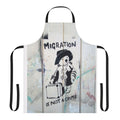 "Apron with the phrase 'Migration Is Not A Crime' in a graffiti-style design"