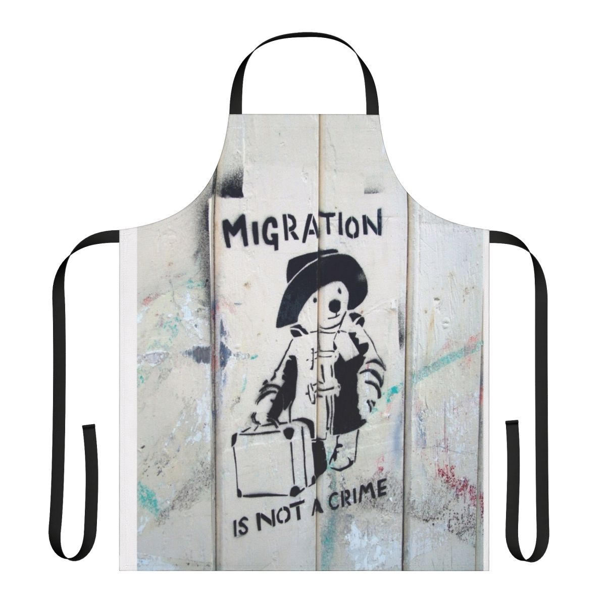 "Apron with the phrase 'Migration Is Not A Crime' in a graffiti-style design"