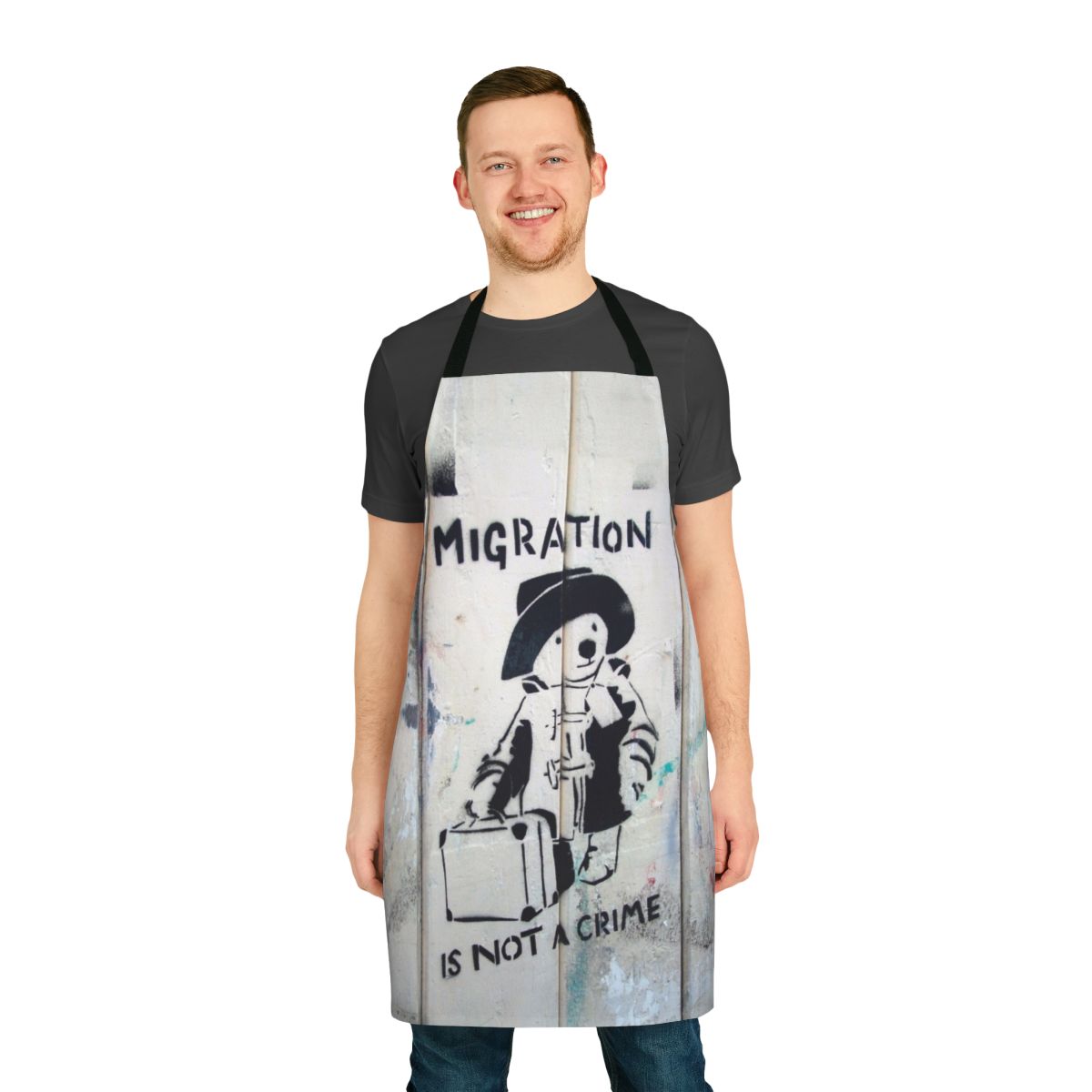 "Apron with the phrase 'Migration Is Not A Crime' in a graffiti-style design"
