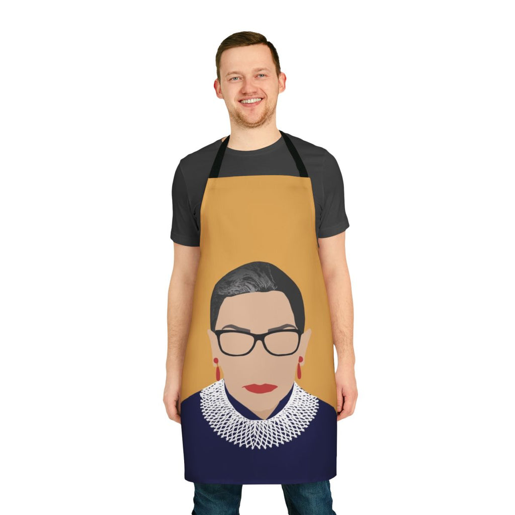 A yellow apron featuring the words "Notorious RBG" and an illustration of Ruth Bader Ginsburg