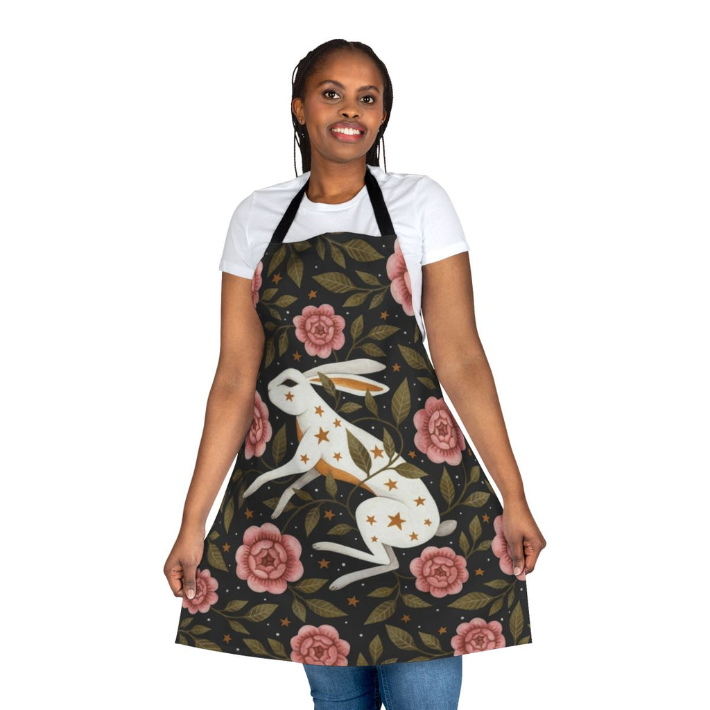 An enchanted apron featuring a dark, mystical floral pattern with bunnies, stars, and nature elements.