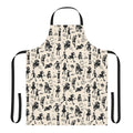 A black and white apron with illustrations of witches, cats, brooms, and other magical elements.