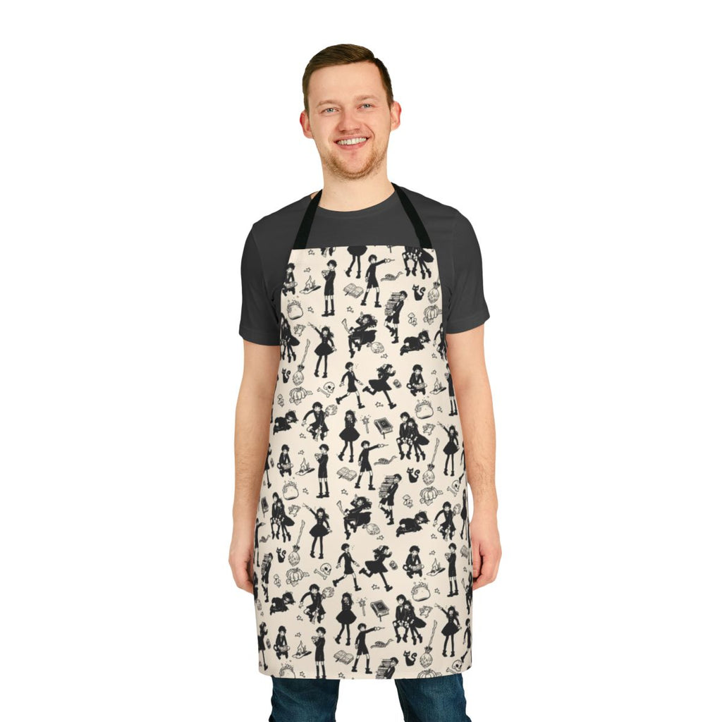 A black and white apron with illustrations of witches, cats, brooms, and other magical elements.