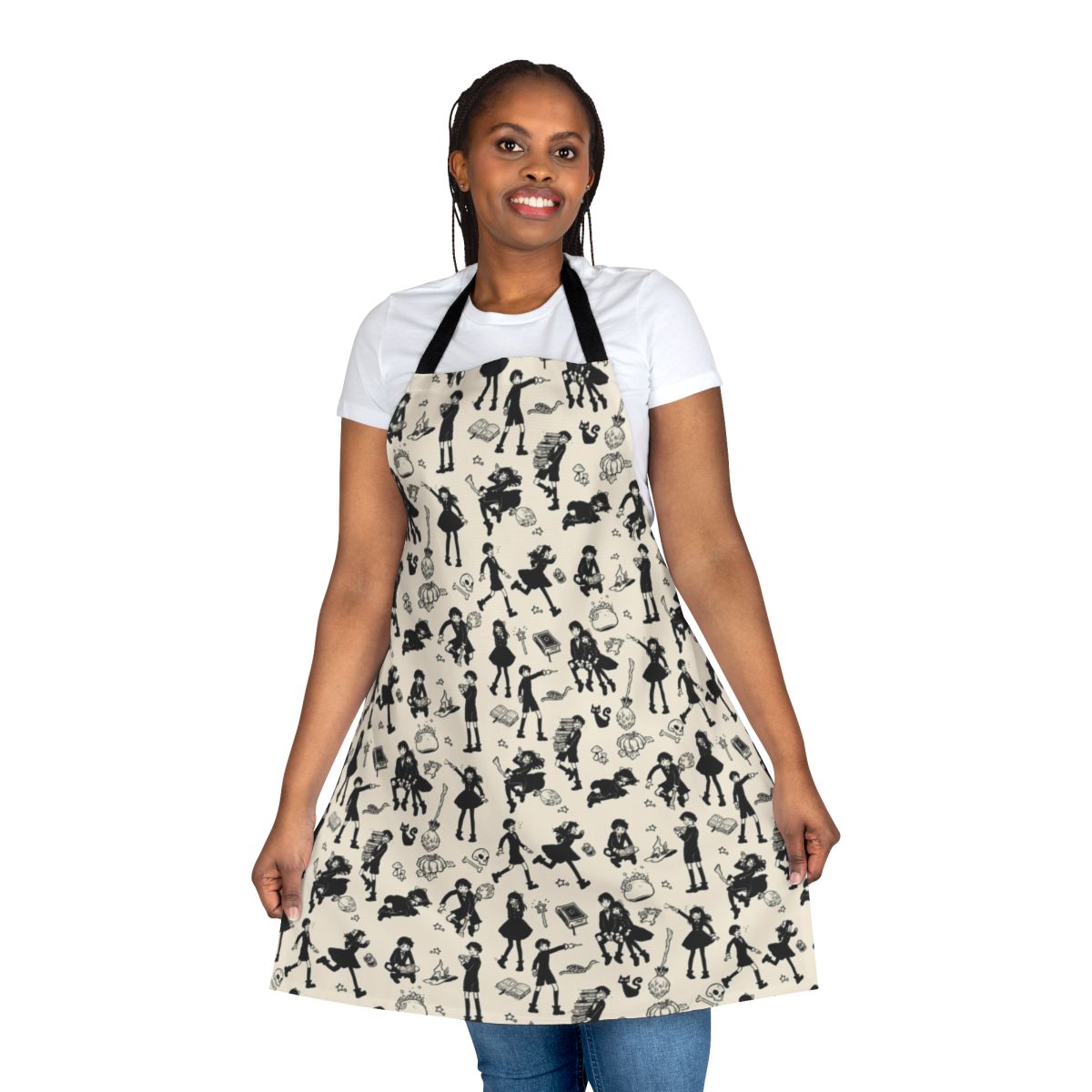 A black and white apron with illustrations of witches, cats, brooms, and other magical elements.