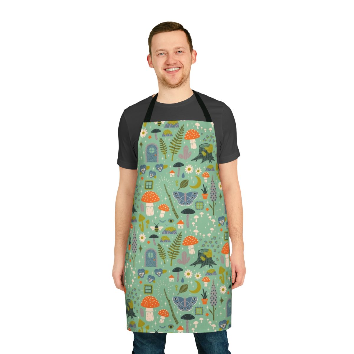 A whimsical floral apron featuring mushrooms, butterflies, and flowers, perfect for gardening or kitchen tasks.