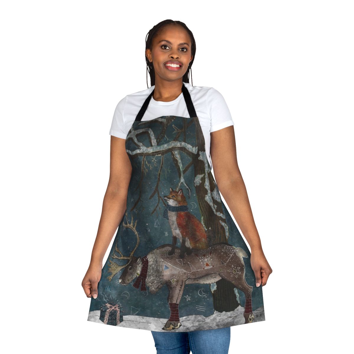A beautifully illustrated apron featuring a winter woodland scene with a snowy forest, foxes, and reindeer.