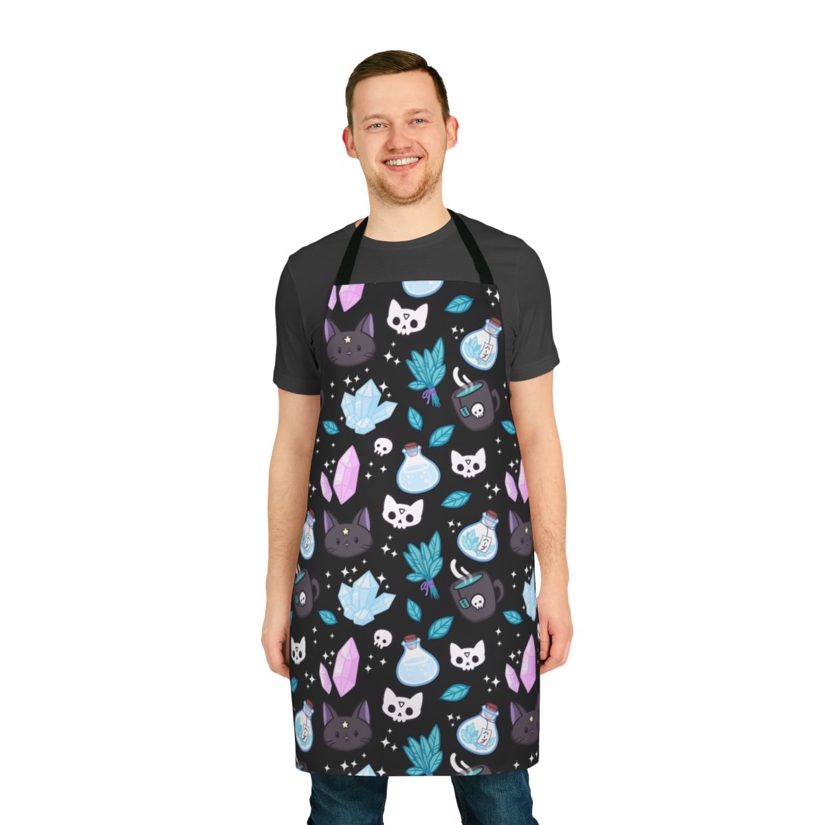 Stylish black apron featuring a whimsical cat skull and floral pattern, perfect for the modern witch or pagan