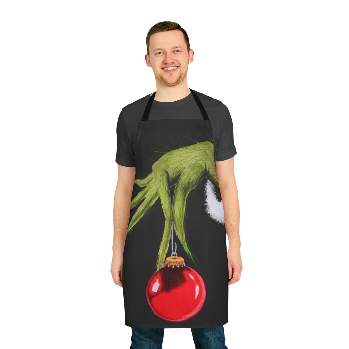 A green and red apron featuring a cartoon Grinch character, perfect for the holiday season