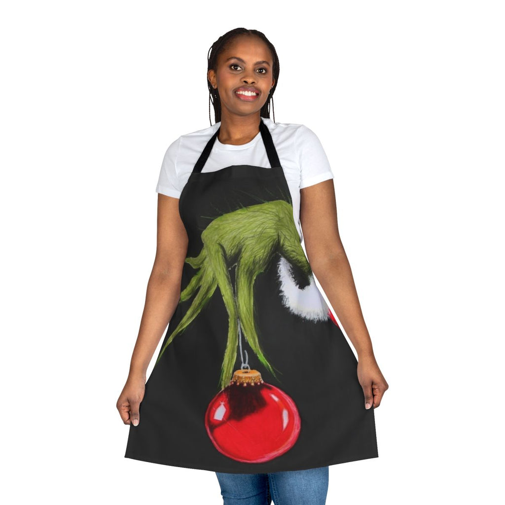 A green and red apron featuring a cartoon Grinch character, perfect for the holiday season