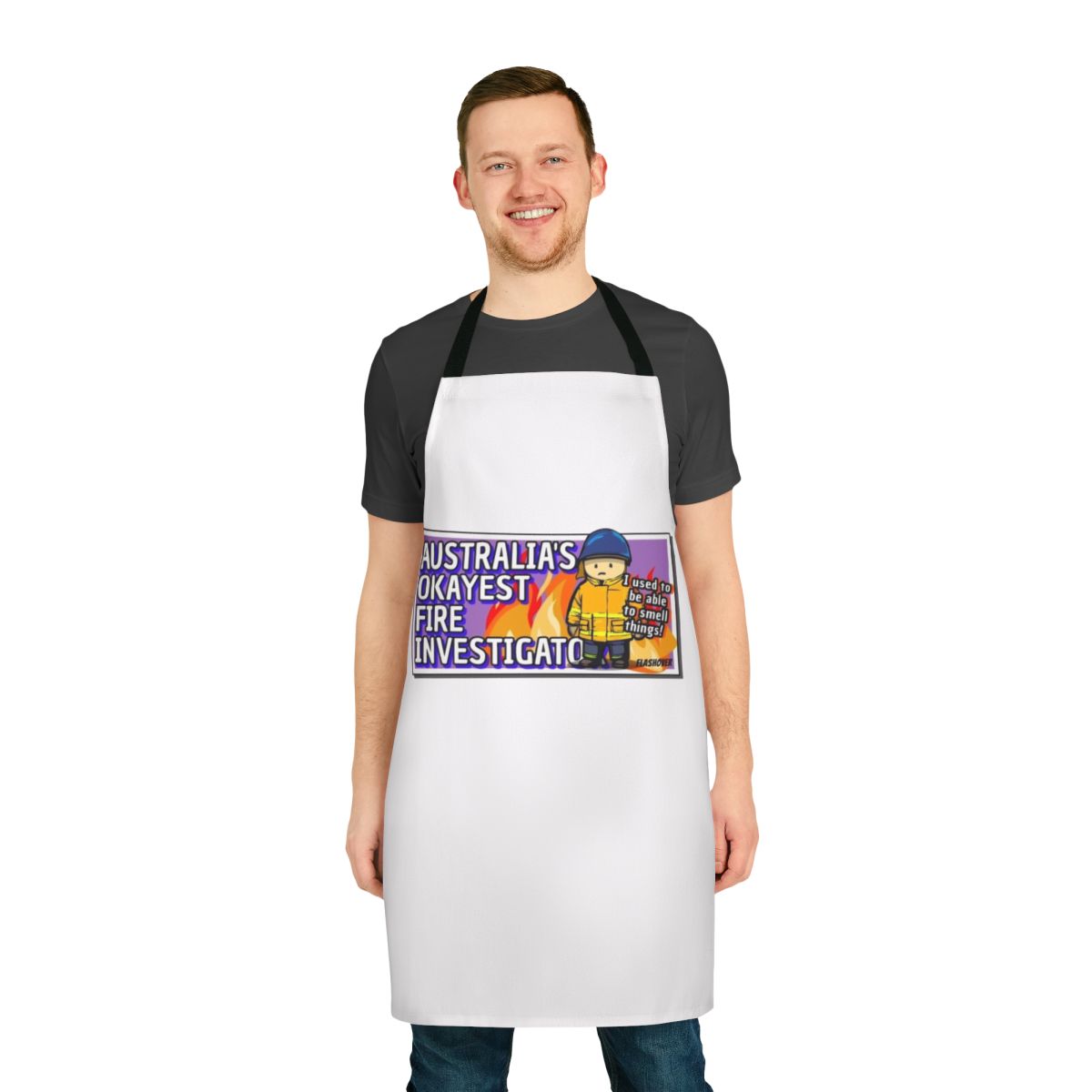 Rural firefighter wearing an apron with "Australia's Okayest Fire Investigator" printed on it