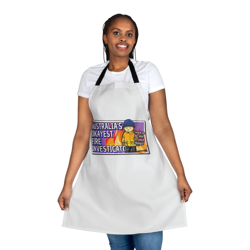 Rural firefighter wearing an apron with "Australia's Okayest Fire Investigator" printed on it
