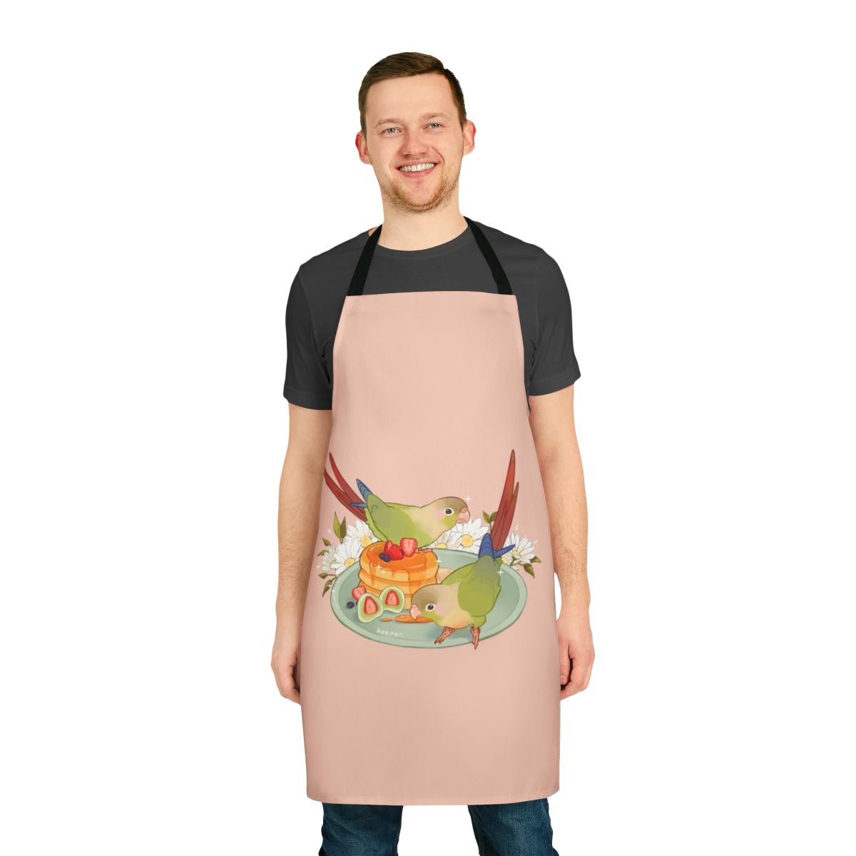 A green conure bird printed on a white apron with a pancake breakfast design