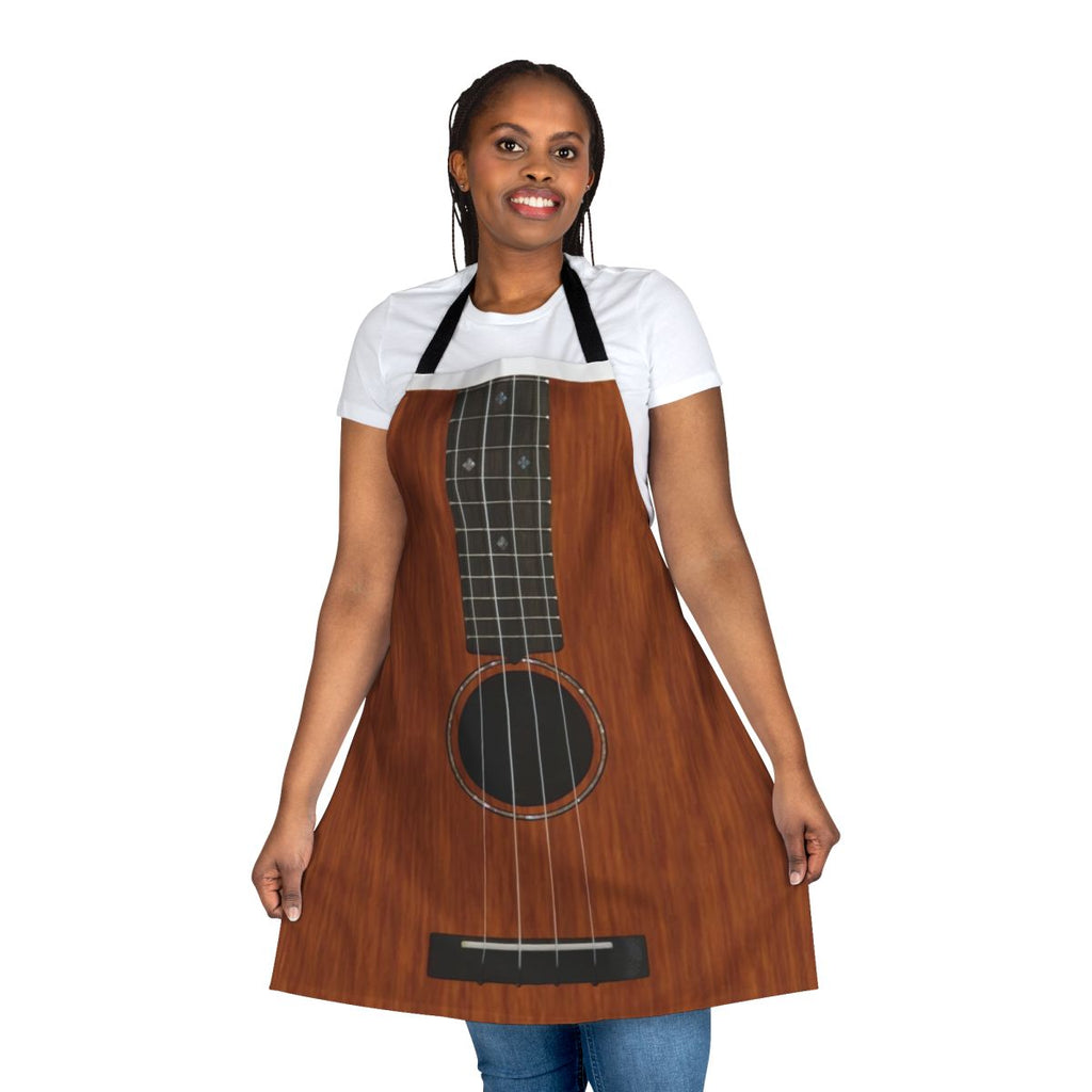 Person wearing apron featuring a ukulele design