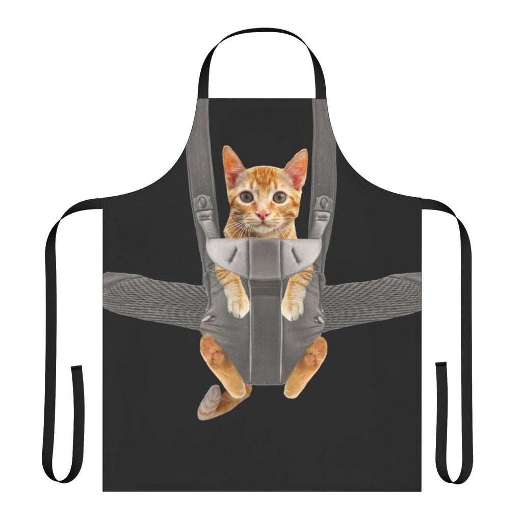 Image of an orange cat sitting in a baby carrier, with the text "Monty The Cat In Baby Carrier Apron"