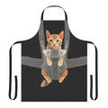 Image of an orange cat sitting in a baby carrier, with the text "Monty The Cat In Baby Carrier Apron"