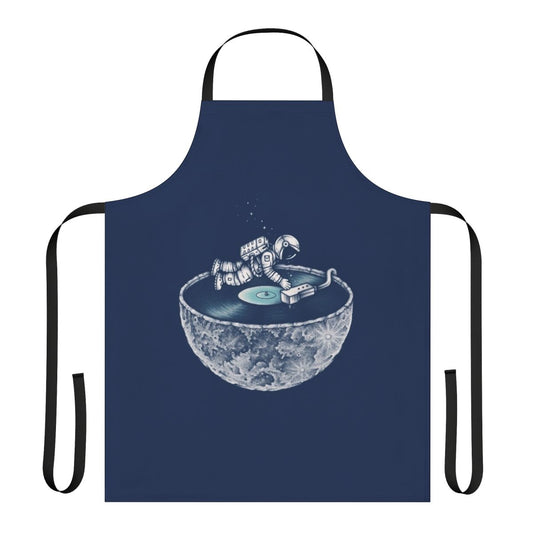 Person wearing a denim apron with a space and music themed design
