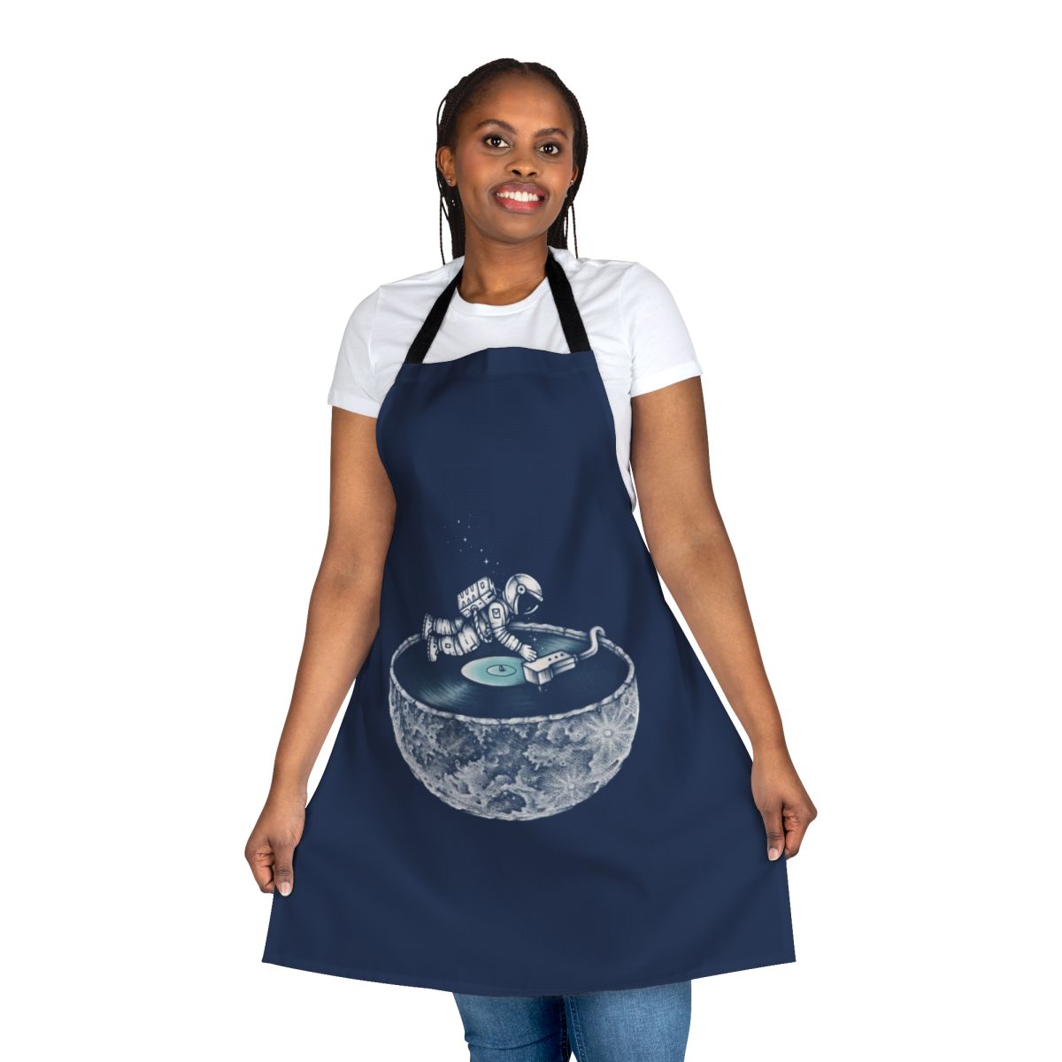 Person wearing a denim apron with a space and music themed design