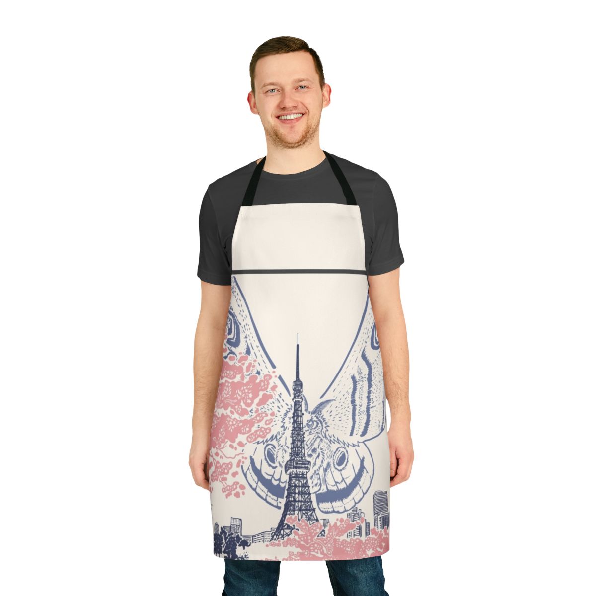 An apron featuring a giant moth creature perched on the iconic Tokyo Tower against a Japanese city skyline.