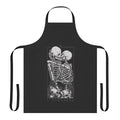 A dark and romantic apron featuring gothic imagery of skulls, flowers, and a couple in embrace.
