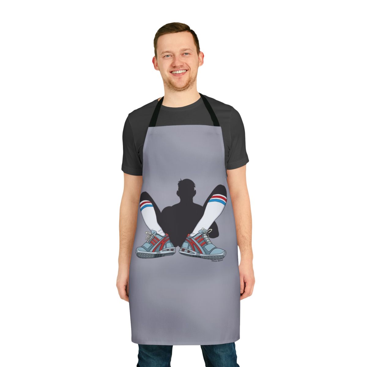 A gray apron designed for active, athletic individuals who enjoy sports and working in the kitchen.