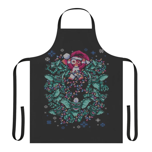 An apron featuring a gremlin-inspired Christmas design with a retro 80s horror movie theme.