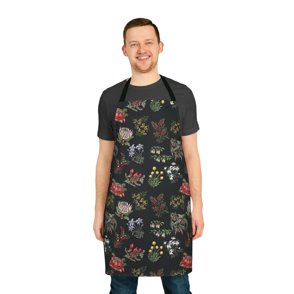 Handcrafted lino print apron featuring vibrant native Australian flowers and foliage.
