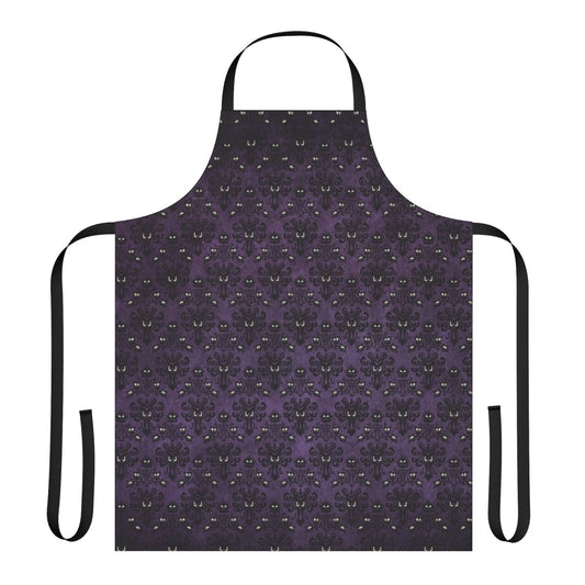 A black and purple apron with a haunted mansion wallpaper design, perfect for spooky kitchen tasks.