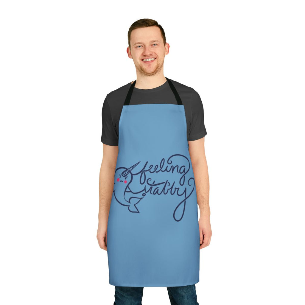 Illustration of a smiling narwhal on a white apron