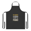 Person wearing an apron with the text "Hobbies Include Sleeping and Playing Piano"