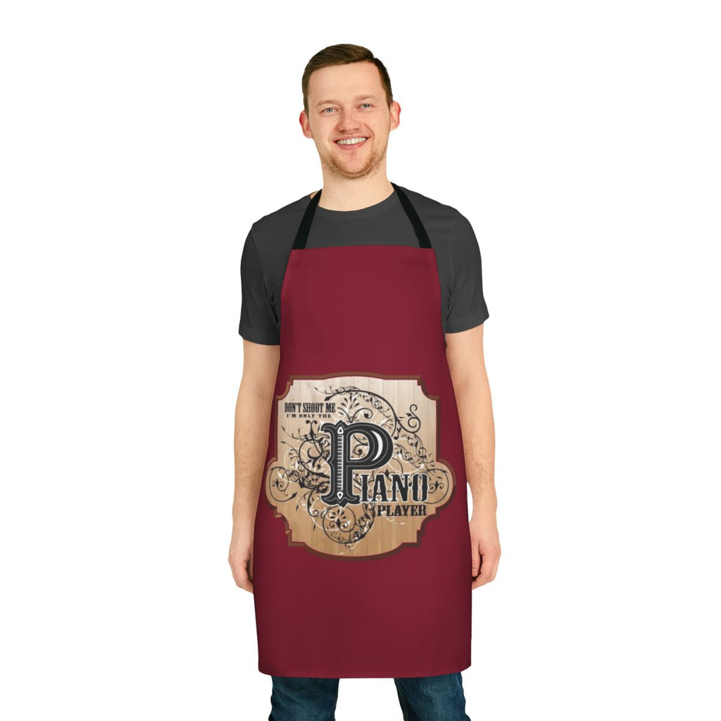 Funny apron featuring the text "Don't Shoot Me, I'm Only the Piano Player" and a playful piano design.