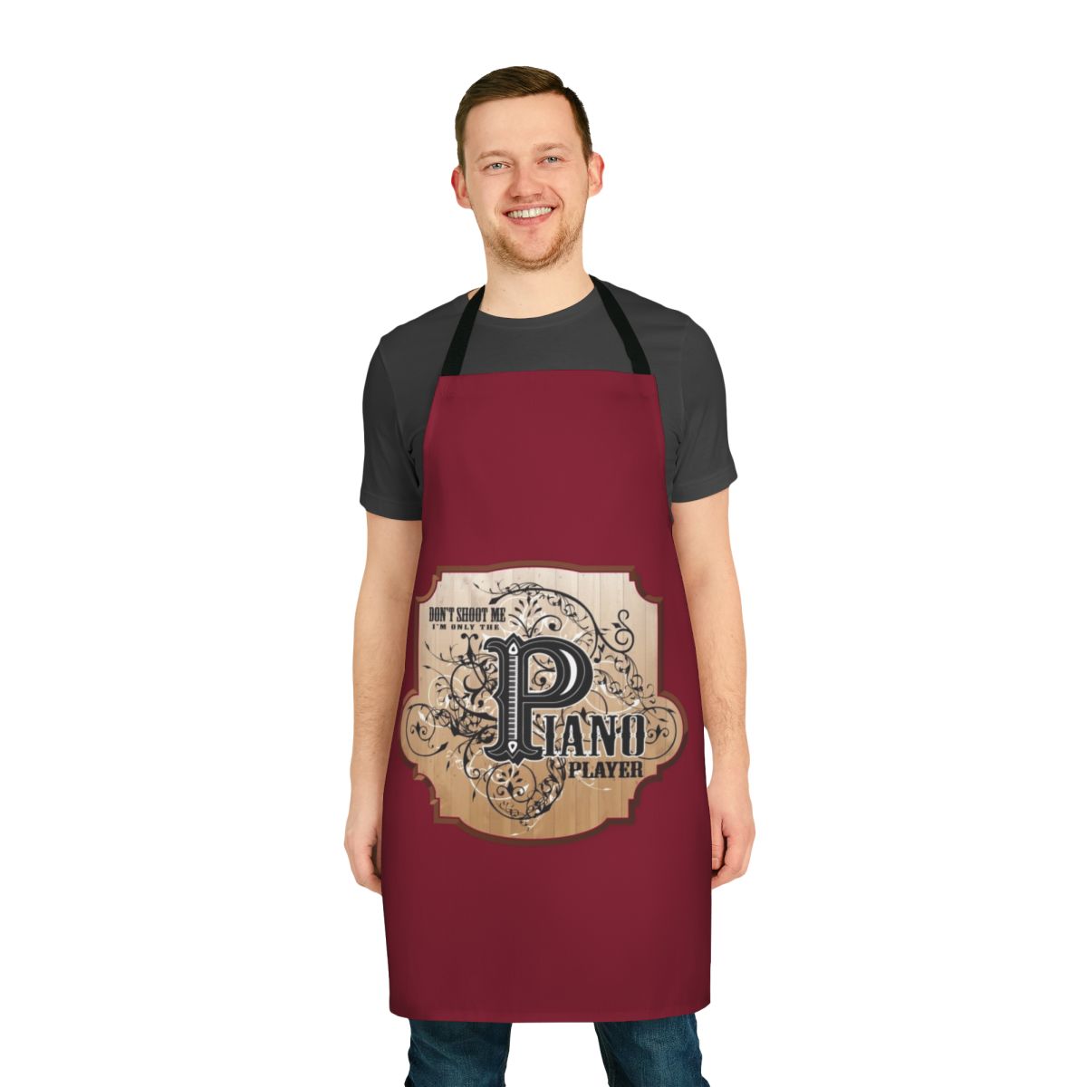 Funny apron featuring the text "Don't Shoot Me, I'm Only the Piano Player" and a playful piano design.