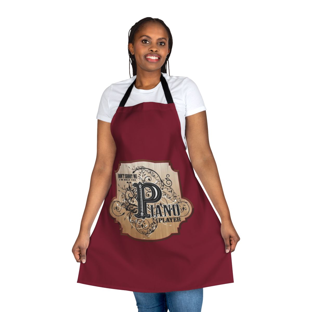 Funny apron featuring the text "Don't Shoot Me, I'm Only the Piano Player" and a playful piano design.