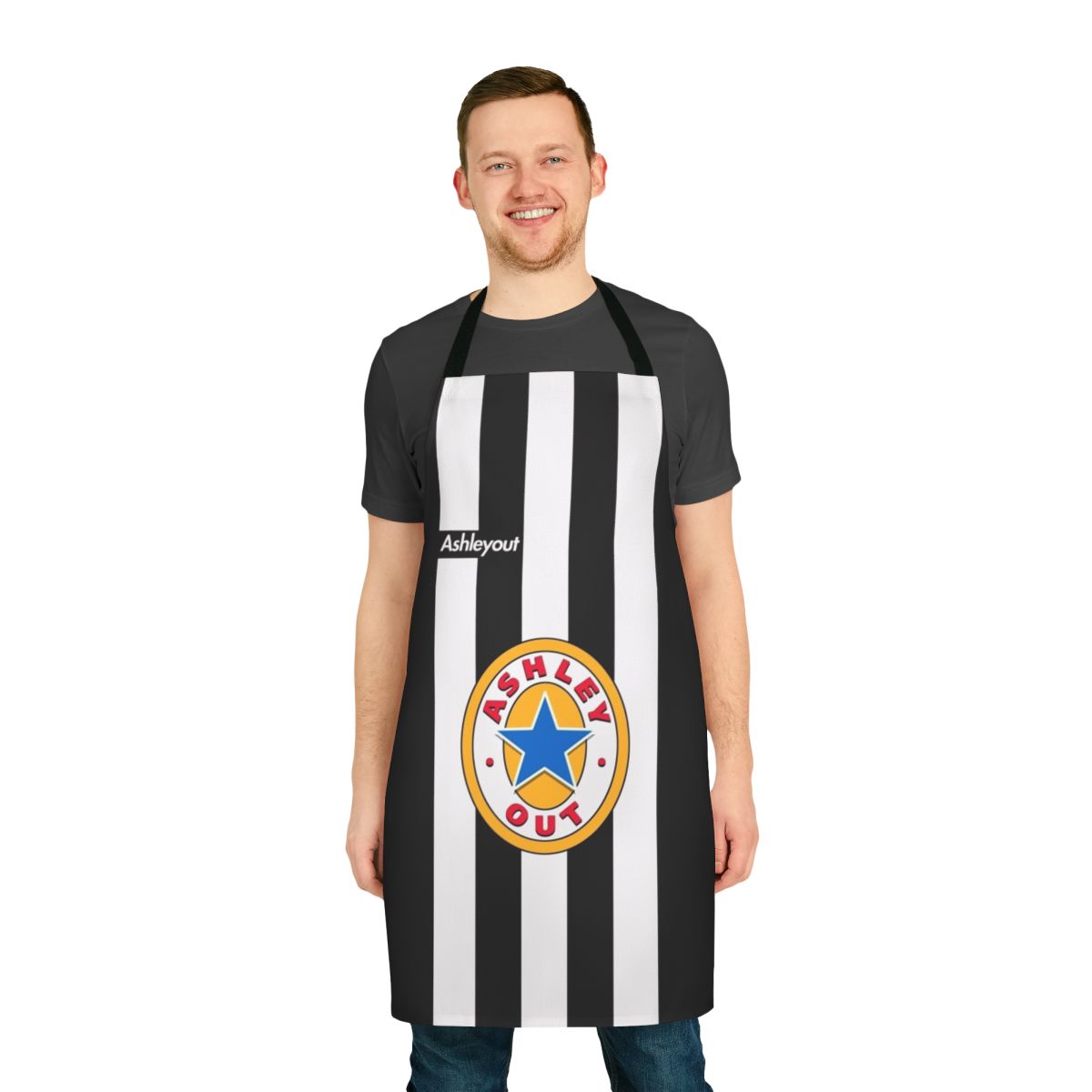 Stylized black and white apron with the text "AshleyOut" and the Newcastle United logo in yellow