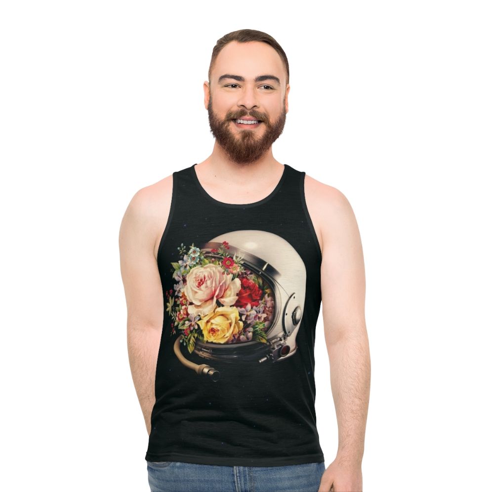 An astronaut in a space suit surrounded by flowers and stars on a cosmic, surreal tank top