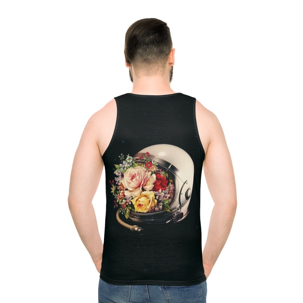 An astronaut in a space suit surrounded by flowers and stars on a cosmic, surreal tank top