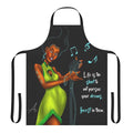 A green apron with an inspirational woman singing into a microphone, featuring a motivational quote.