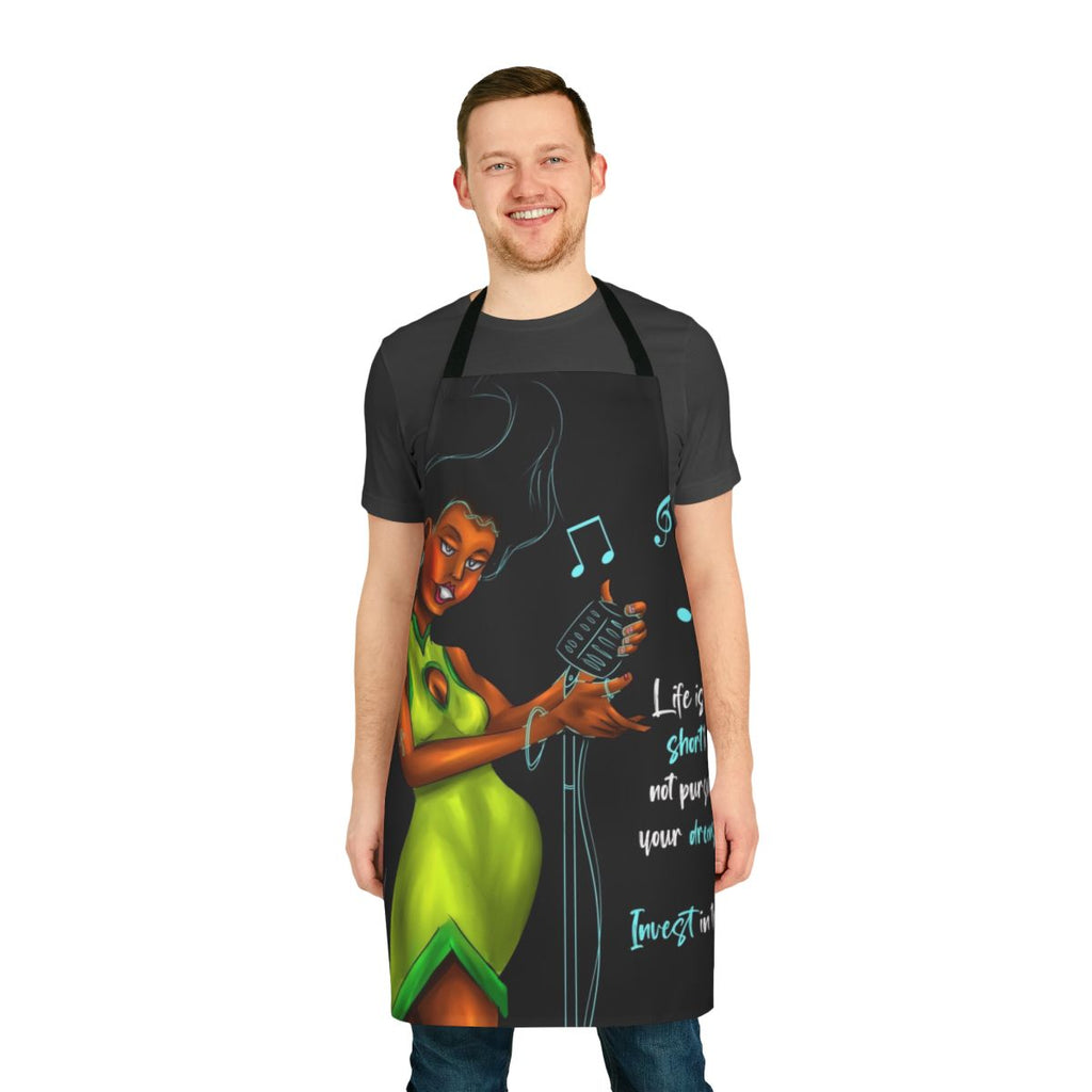 A green apron with an inspirational woman singing into a microphone, featuring a motivational quote.