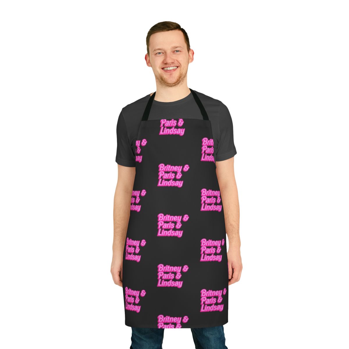 Baby pink apron with Barbie-inspired font, featuring the names of iconic millennial celebrities Britney Spears, Paris Hilton, and Lindsay Lohan.
