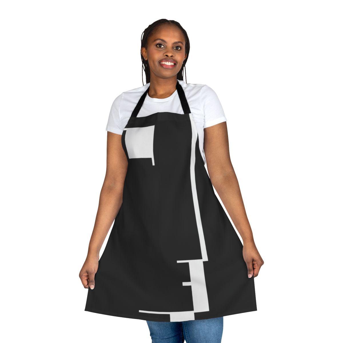A black and white apron featuring a minimalist Bauhaus-inspired design with a face profile and geometric shapes.