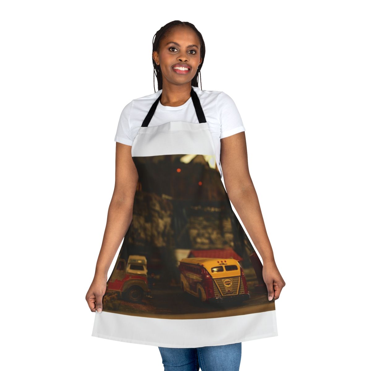 Person wearing a navy blue apron with a model train design