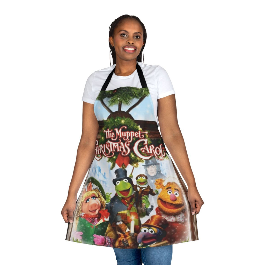 A red apron featuring characters from the Muppet Christmas Carol movie, including Kermit the Frog and Miss Piggy.