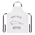 A playful apron with the text "Hobbies Include Napping" printed on it, perfect for the casual napping aficionado.