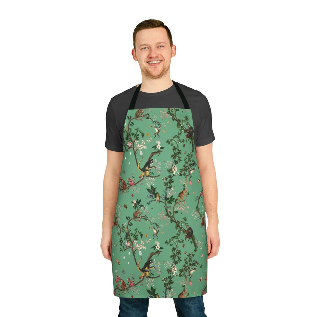 Lively and vibrant green apron featuring a monkey-themed floral design, perfect for the eco-conscious kitchen.