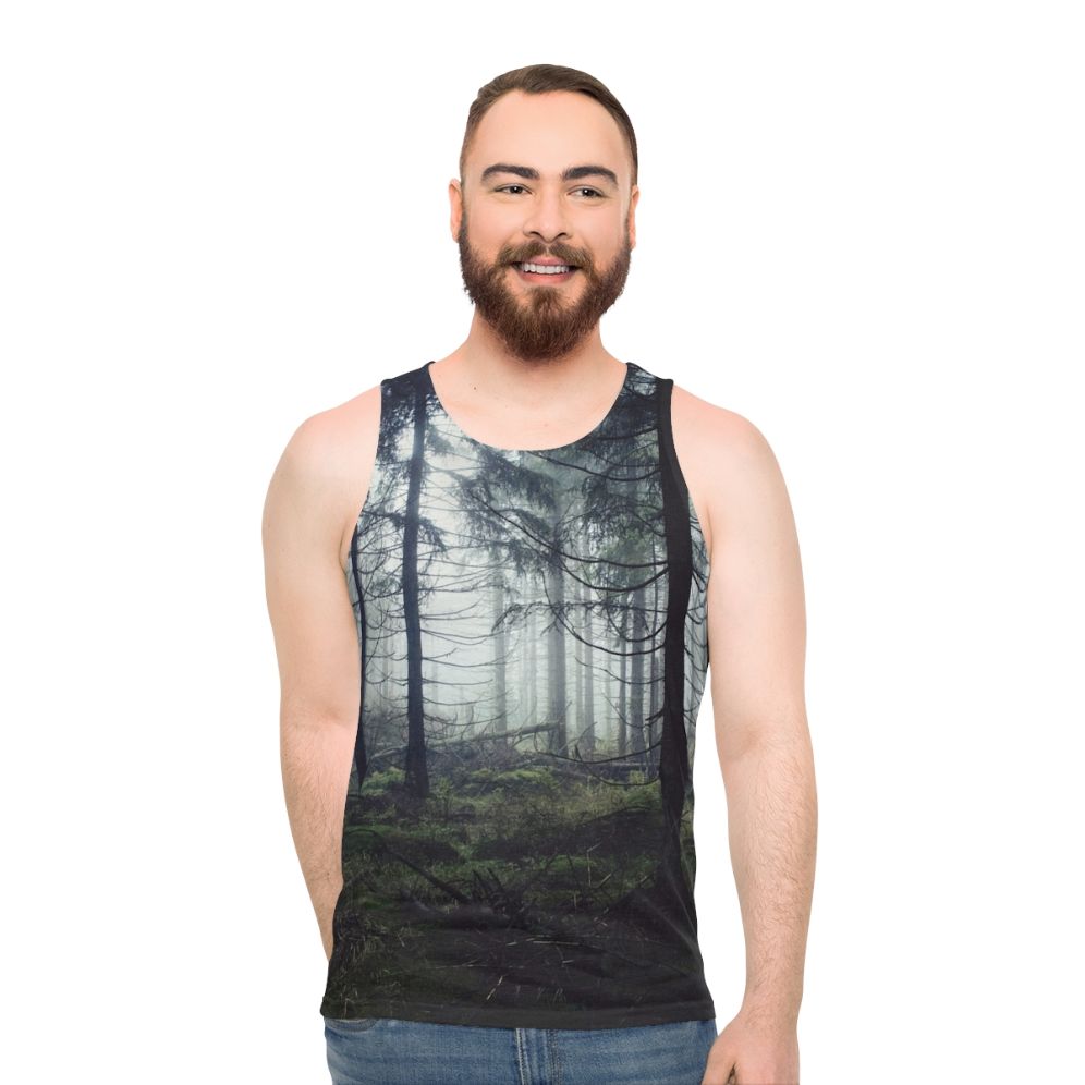 Person wearing unisex nature tank top standing in a forest
