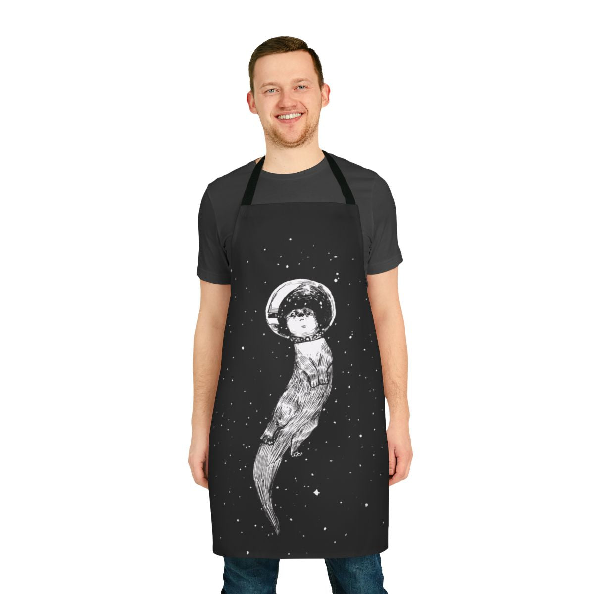 Whimsical apron with an illustration of an otter floating peacefully through a starry outer space scene