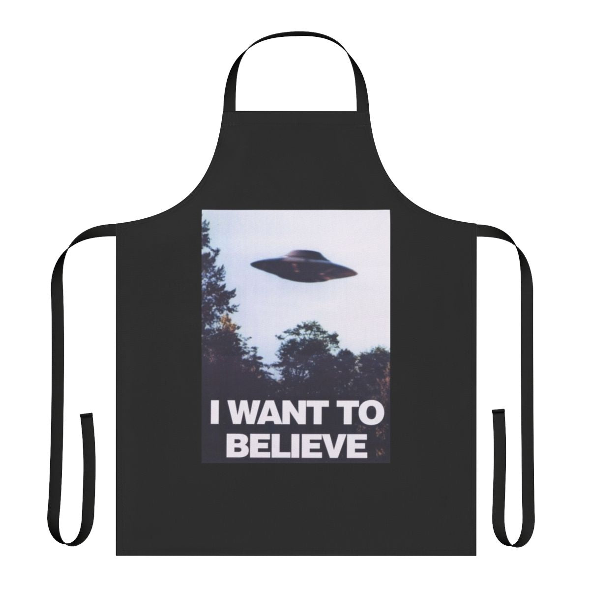 A black apron with an "I Want to Believe" graphic, featuring spooky elements like UFOs and aliens.
